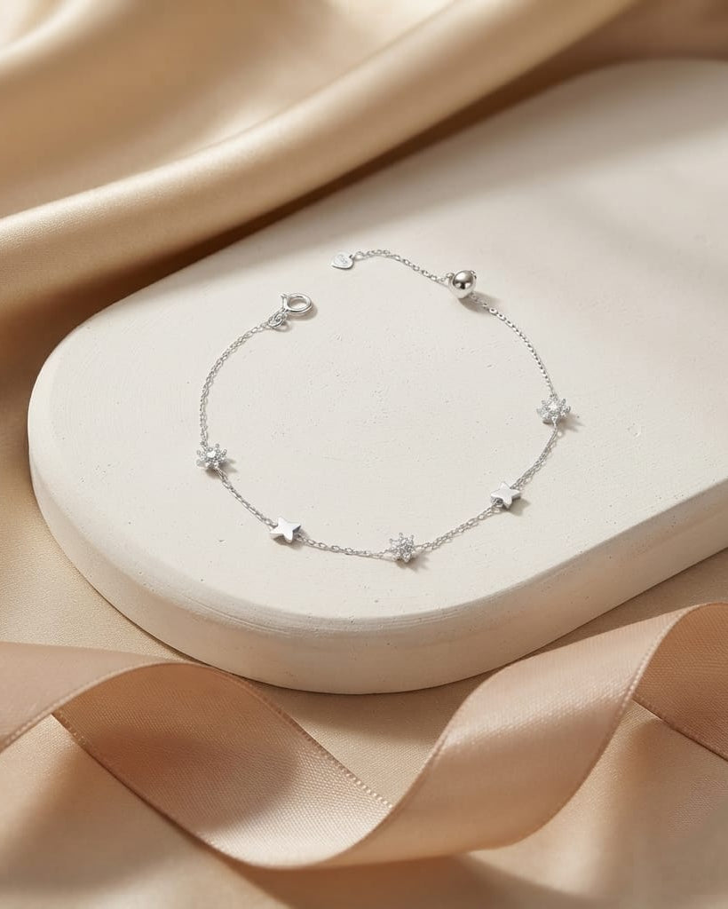 925 Sterling Silver celestial star station bracelet with polished and pavé charms.
