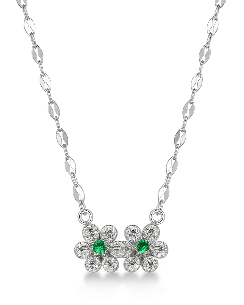 Silver necklace with flower-shaped pendants featuring green gemstones on a white background #color_silver
