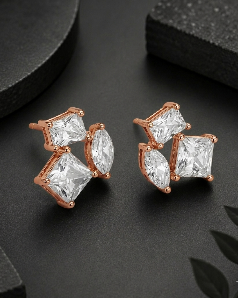 Rose gold earrings with clear gemstones on a dark surface #color_rose gold