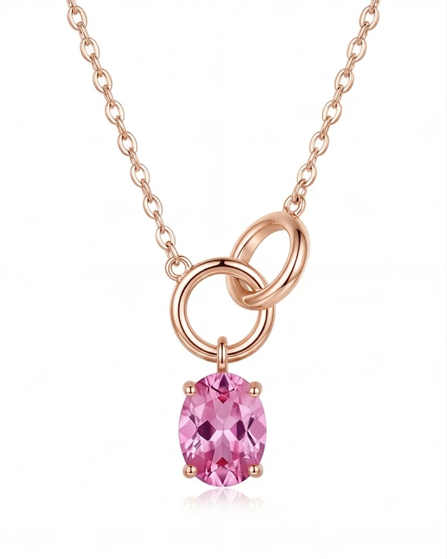 Gold necklace with a pink gemstone pendant on a white background #color_rose gold