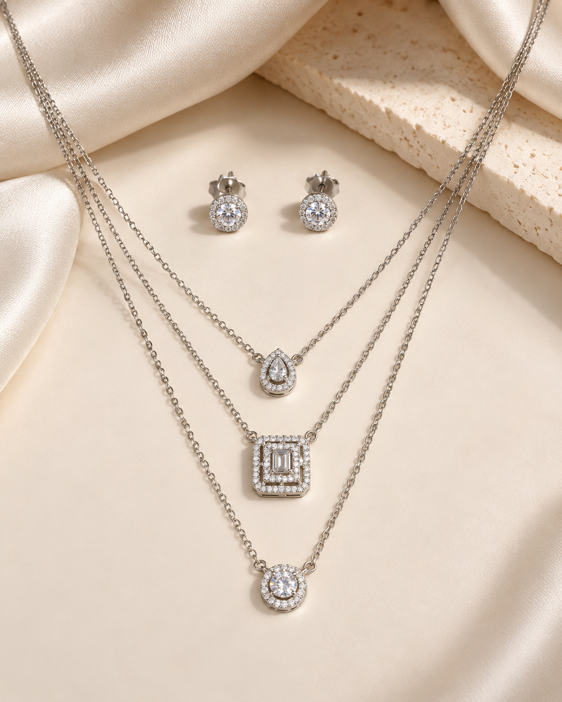 Geometric layered necklace and earrings set with sparkling white accents