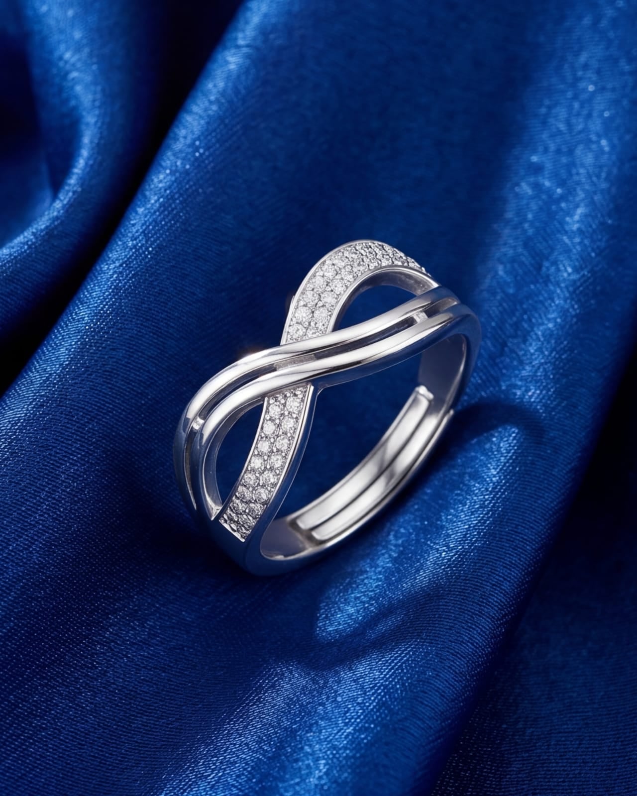 Silver ring with diamond accents on a blue satin background #color_silver