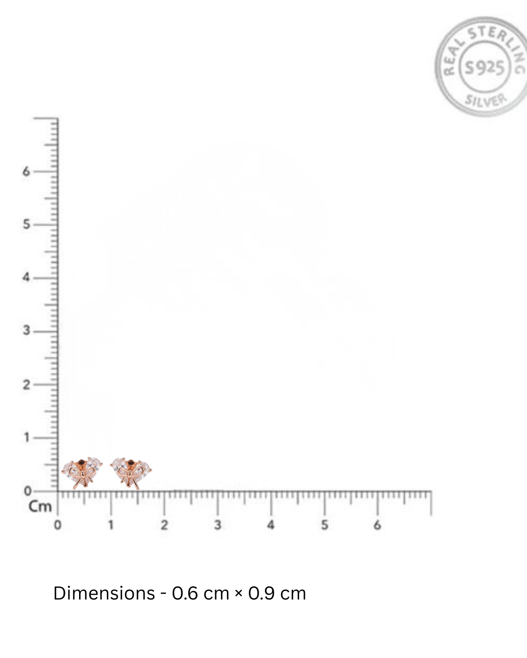 Small earrings with a ruler for scale on a white background, featuring 'Real Sterling Silver' stamp.