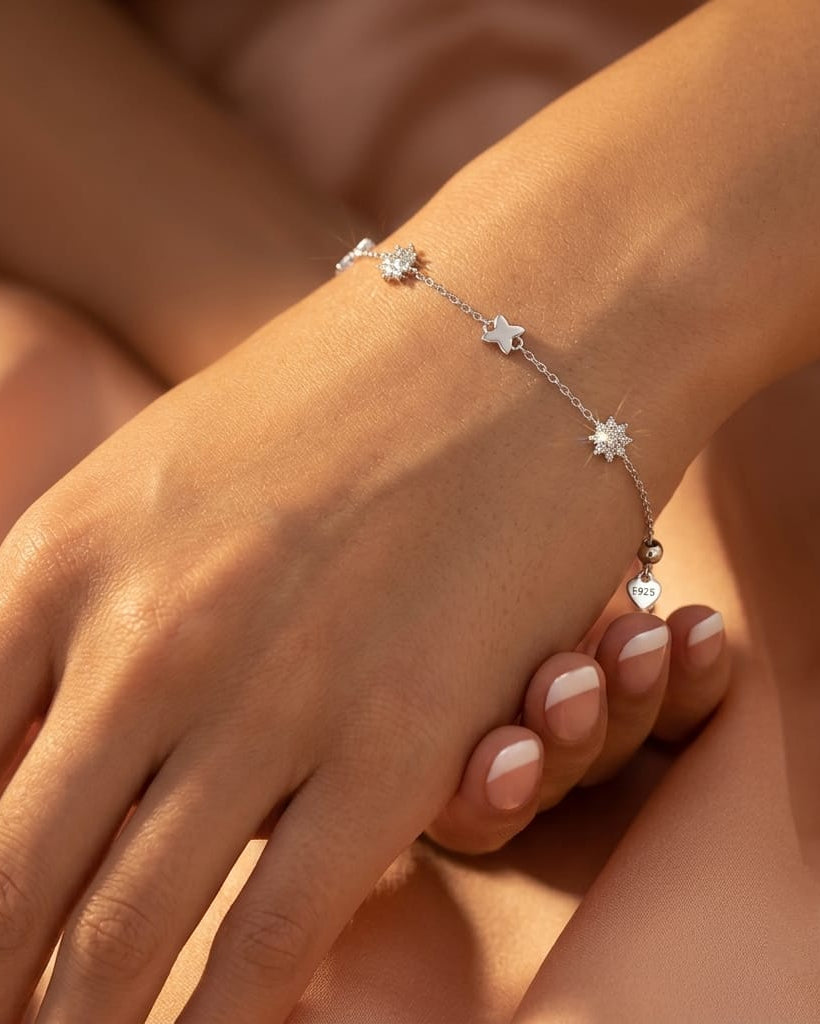 925 Sterling Silver celestial star station bracelet with polished and pavé charms.