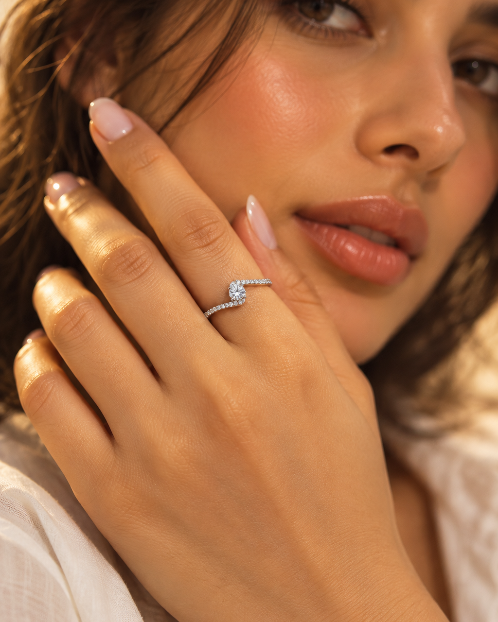 Round centre stone crossover ring with curved band