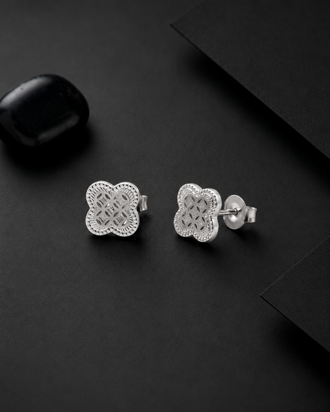 Silver floral earrings on a black surface #color_silver
