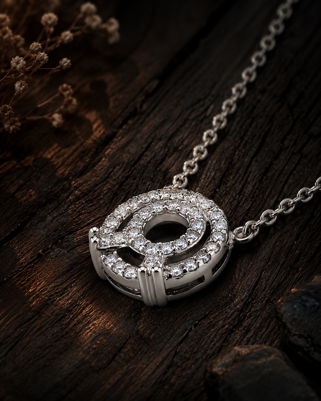 Silver necklace with a circular pendant on a wooden surface