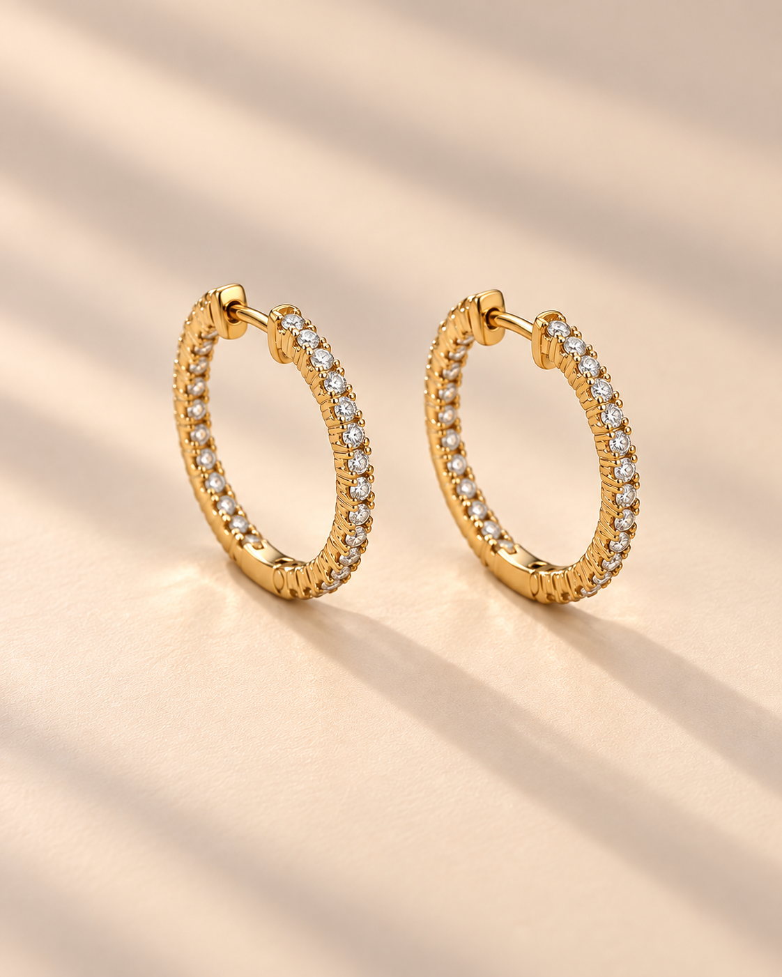 Gold hoop earrings with embedded stones on a white background #color_gold