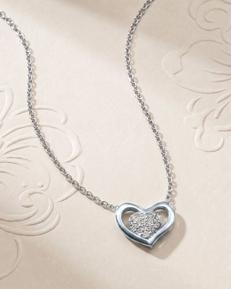 Silver heart-shaped necklace with a diamond on an embossed beige background #color_silver
