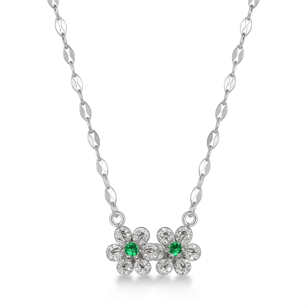 Silver necklace with flower-shaped pendants featuring green gemstones on a white background #color_silver
