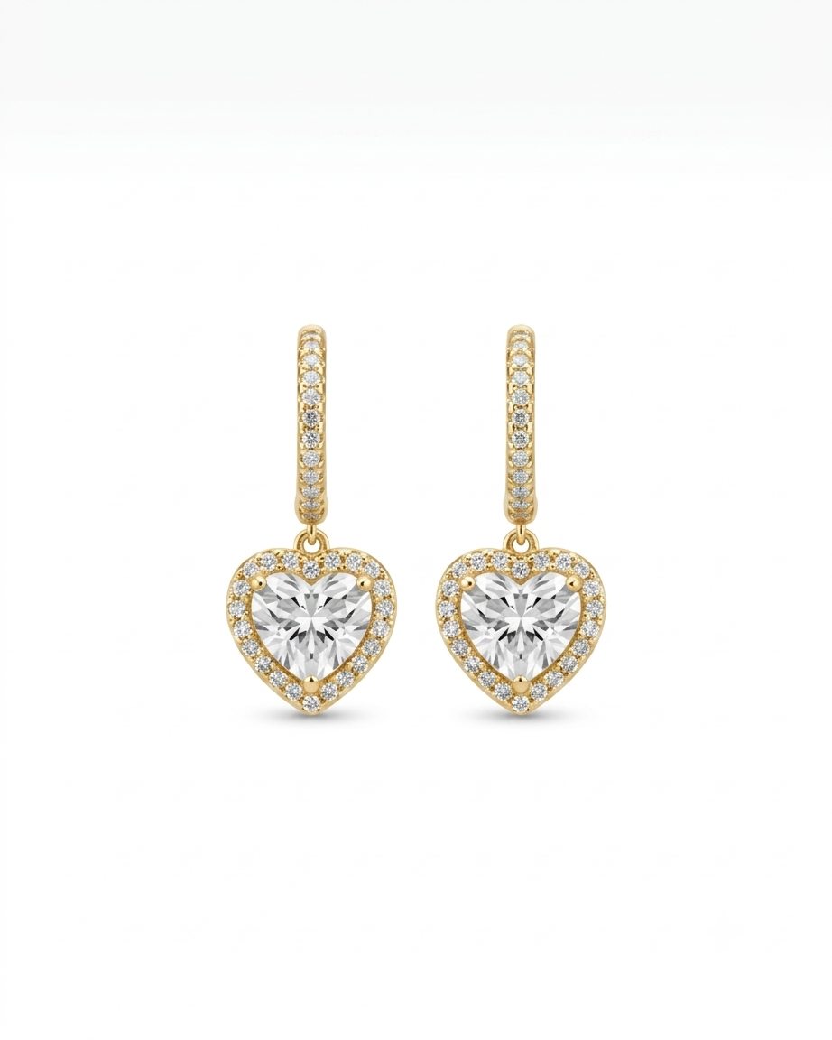 Heart-shaped earrings with clear gemstones on a white background#color_gold