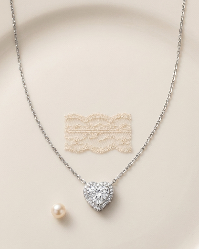 Heart-shaped diamond necklace on a beige background #colour_silver