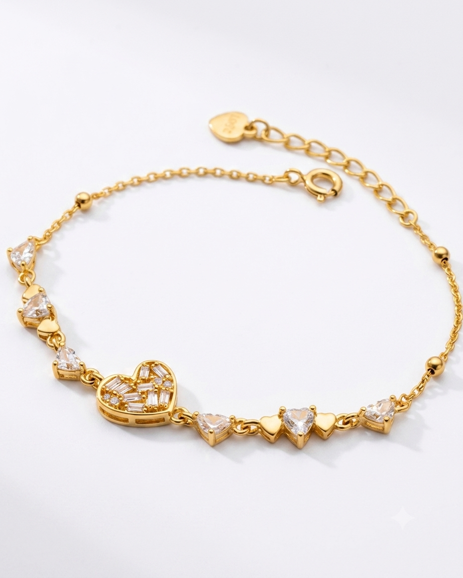 Gold bracelet with heart and clear stone design on a white background #color_gold 