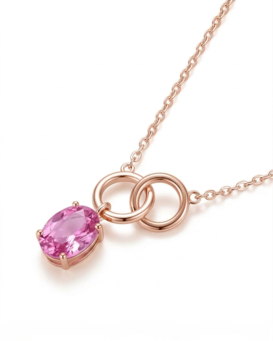 Rose gold necklace with a pink gemstone on a white background #color_rose gold