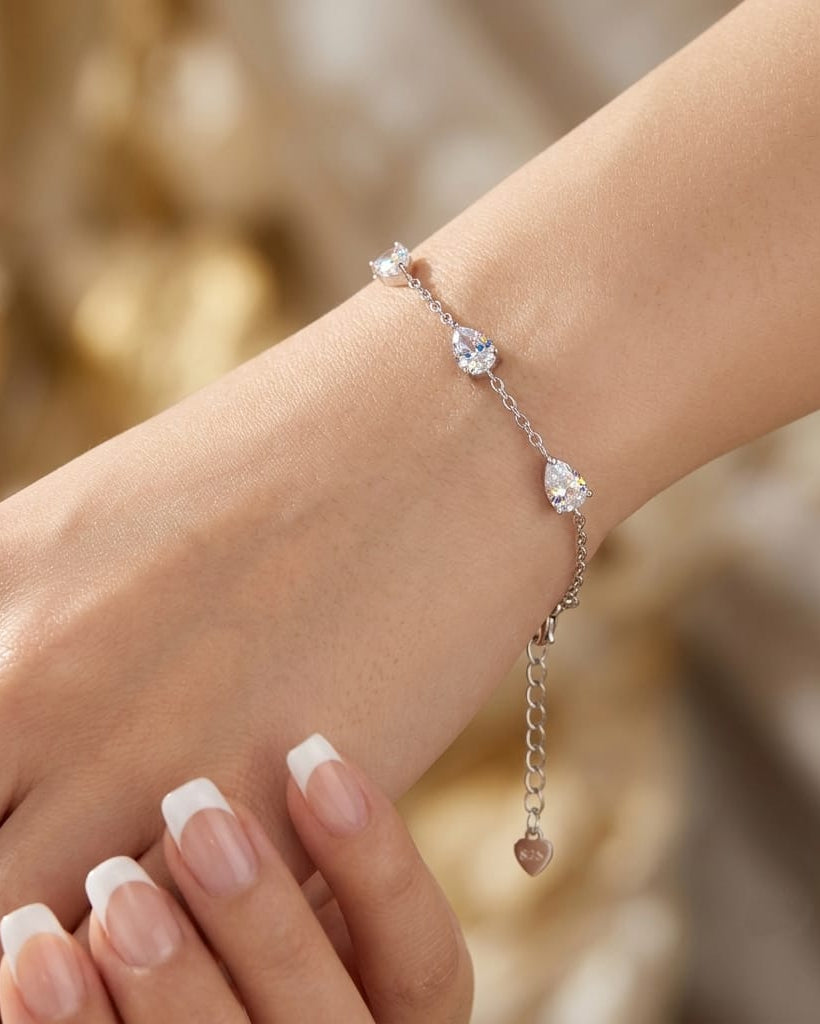 925 Sterling Silver pear-cut station chain bracelet with adjustable lobster clasp.